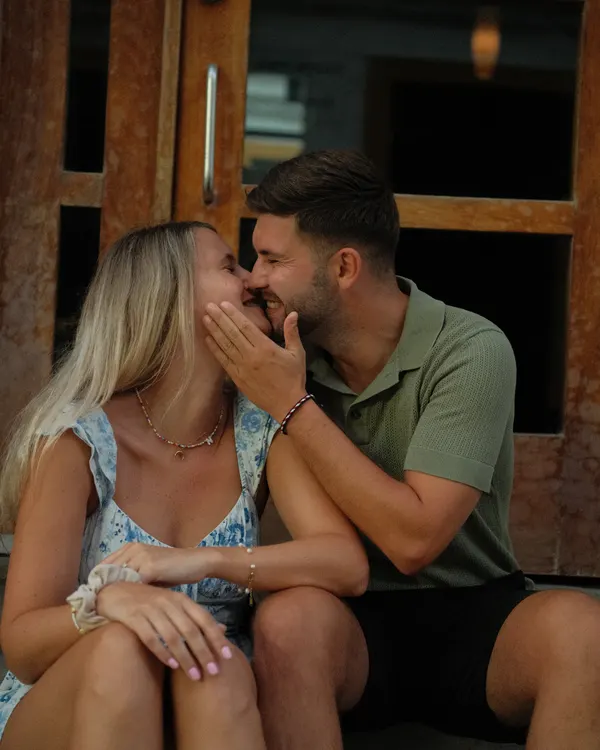 Couple laughing on a doorstep in Cádiz