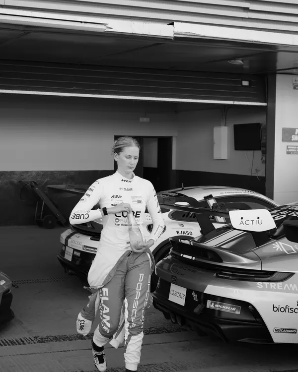 Black-and-white photo of a racing driver in the paddock in Jerez