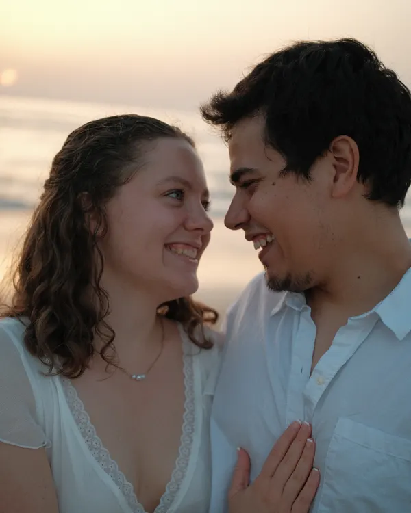 Couple dancing on the beach at dusk